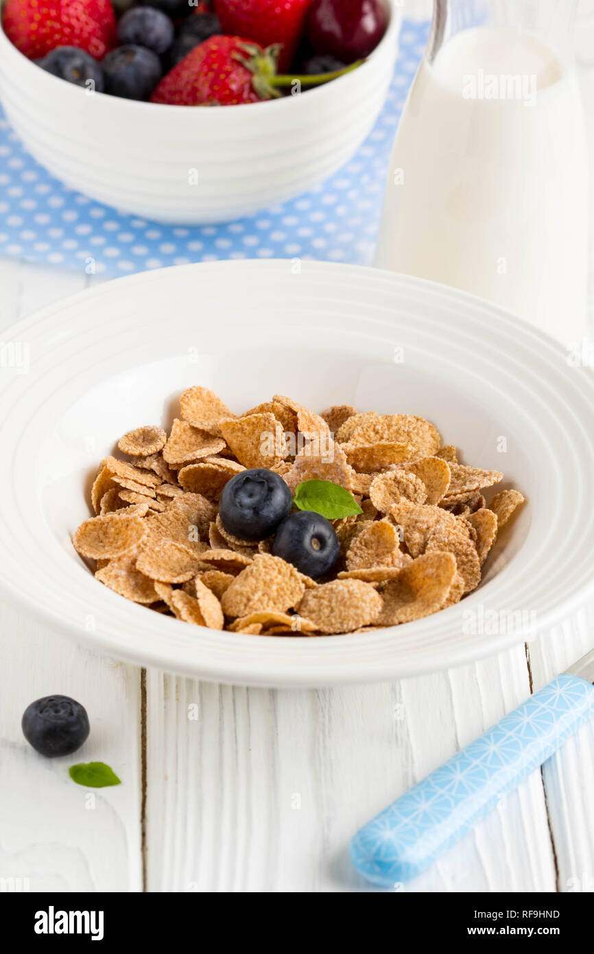 Multi-slag flakes for Breakfast with berries and milk, muesli, corn Stock Photo