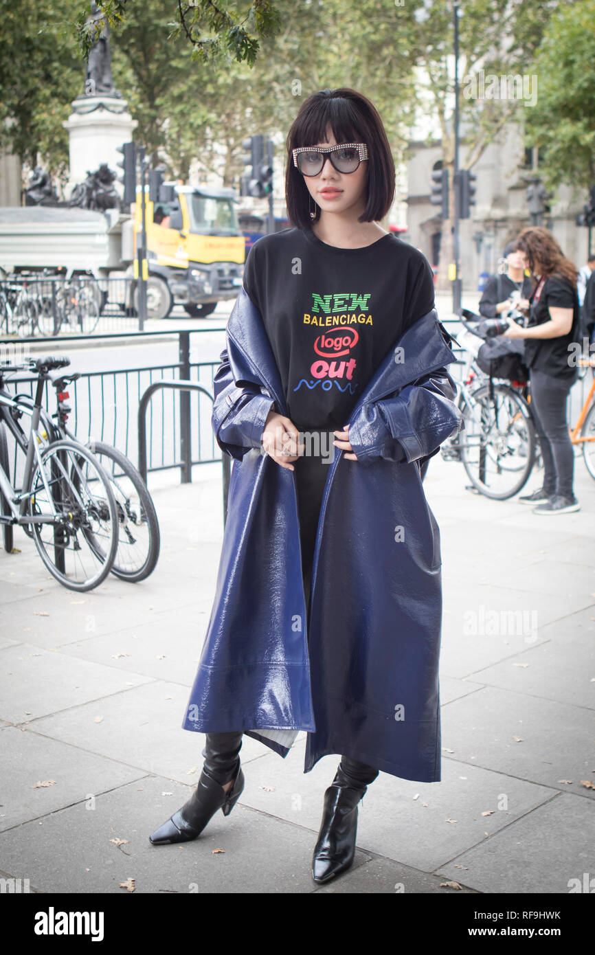 LONDON, UK- SEPTEMBER 14 2018: People on the street during the London  Fashion Week. Chinese blogger Girl in a balenciaga shirt and a long blue  raincoa Stock Photo - Alamy