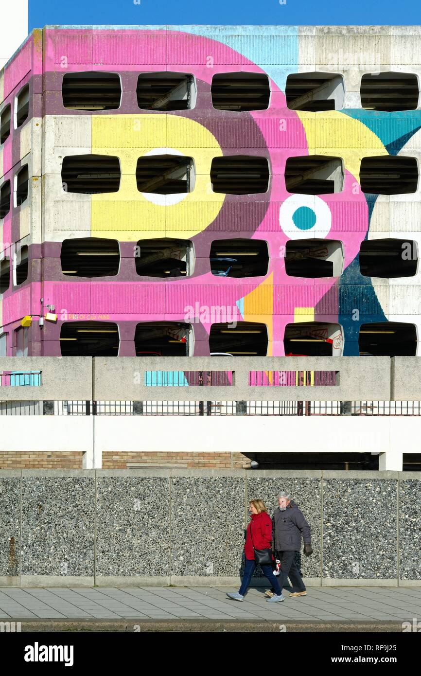 Detail of the Grafton multi storey car park with elderly couple walking past, Worthing seafront West Sussex England UK Stock Photo