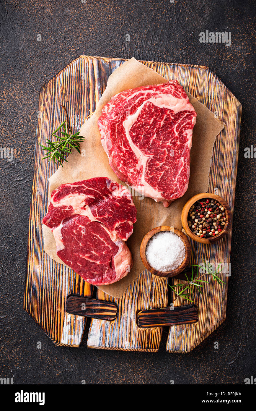 Raw marbled ribeye steak and spices Stock Photo