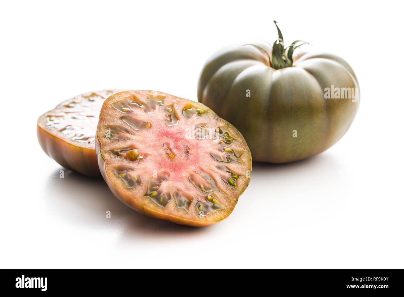 Dark brandywine tomatoes isolated on white background. Stock Photo