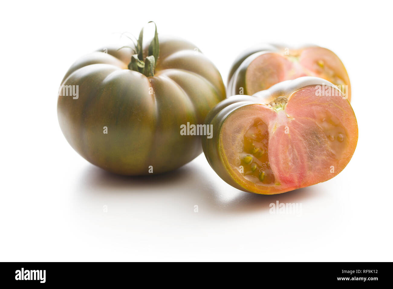 Dark brandywine tomatoes isolated on white background. Stock Photo