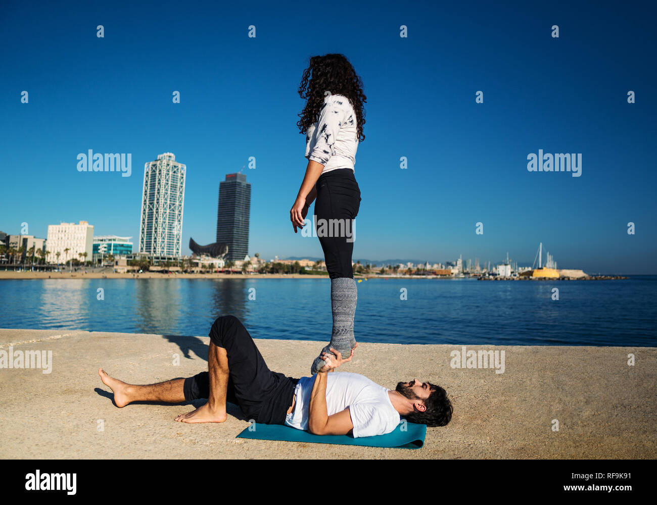 Beautiful couple practicing acro yoga in the morning Stock Photo
