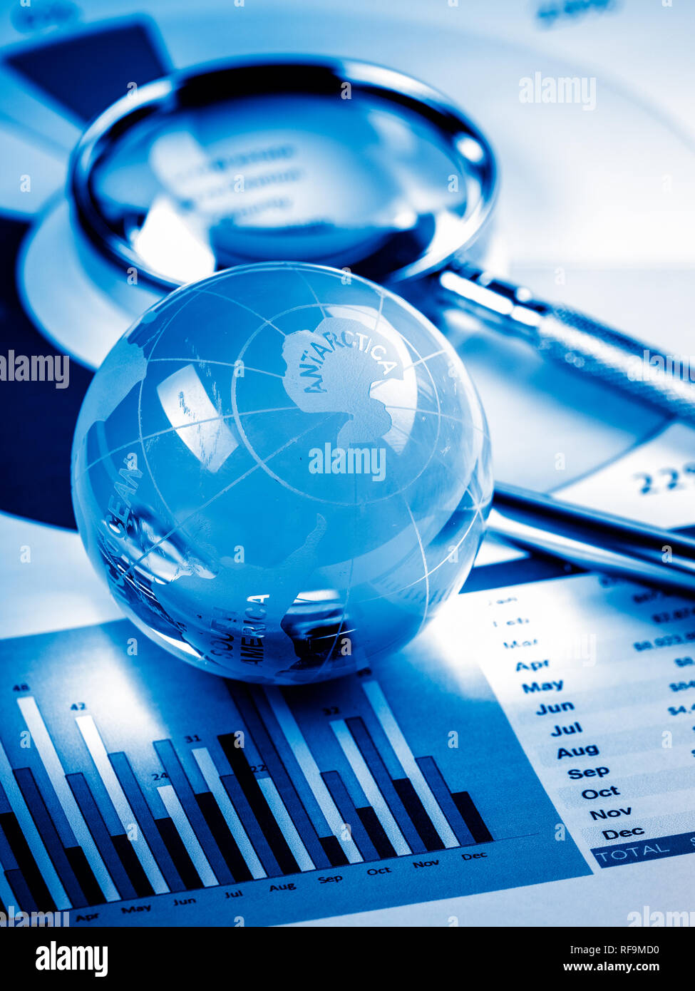 Business Data Analyzing, with magnifying glass and other on the desk ...