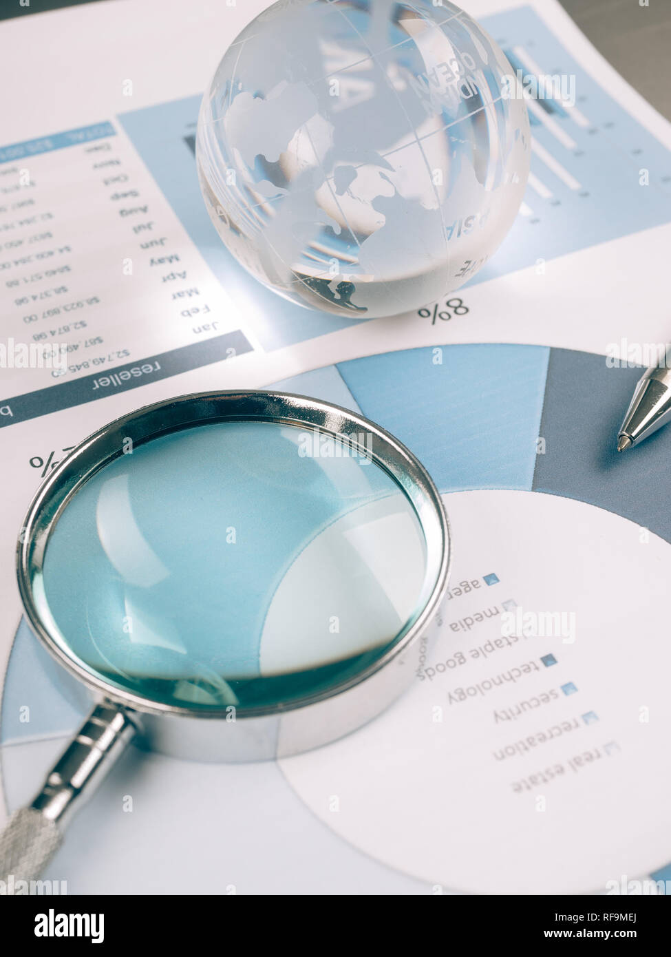 Business Data Analyzing, with magnifying glass and other on the desk ...