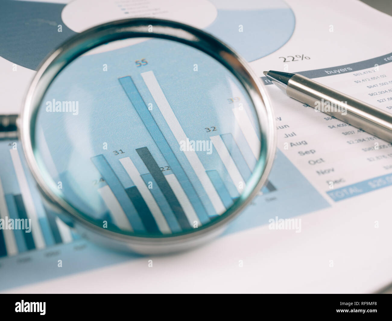 Business Data Analyzing, with magnifying glass and other on the desk ...