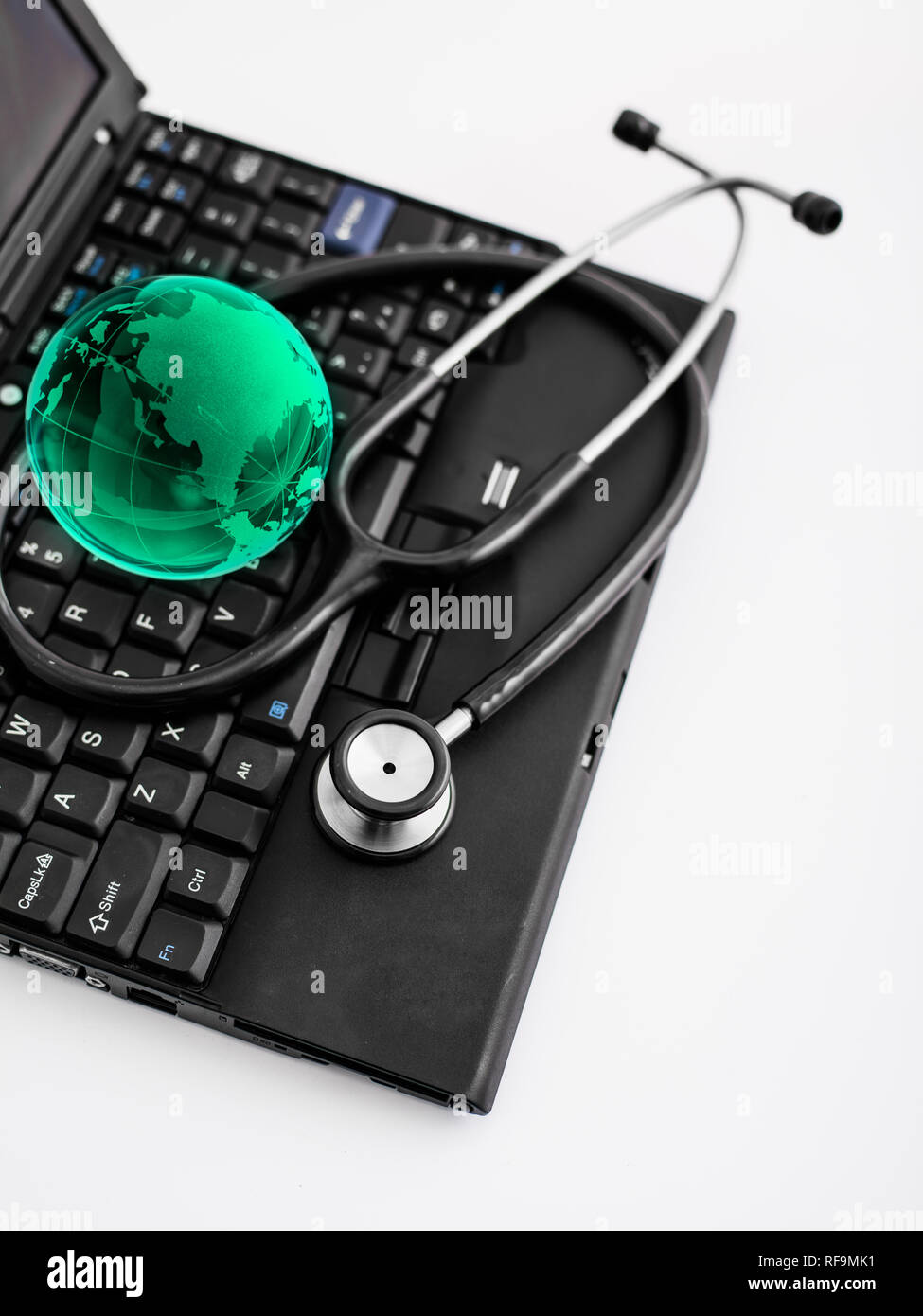 Glass globe and stethoscope on a computer keyboard Stock Photo - Alamy