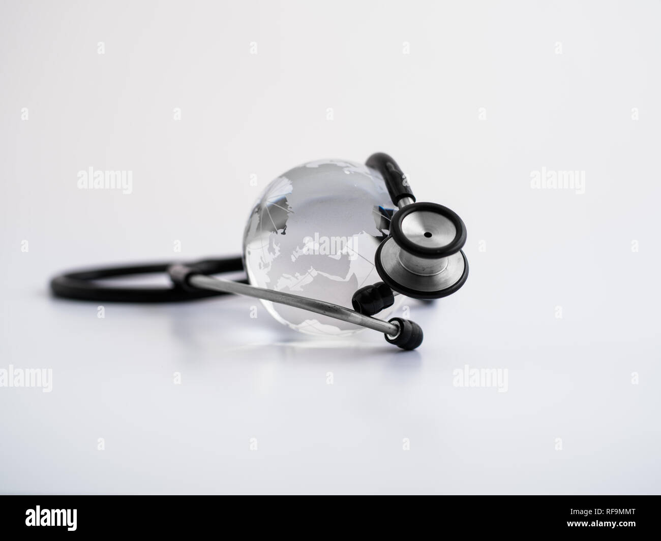 Global healthcare. Globe and stethoscope, studio shot Stock Photo Alamy