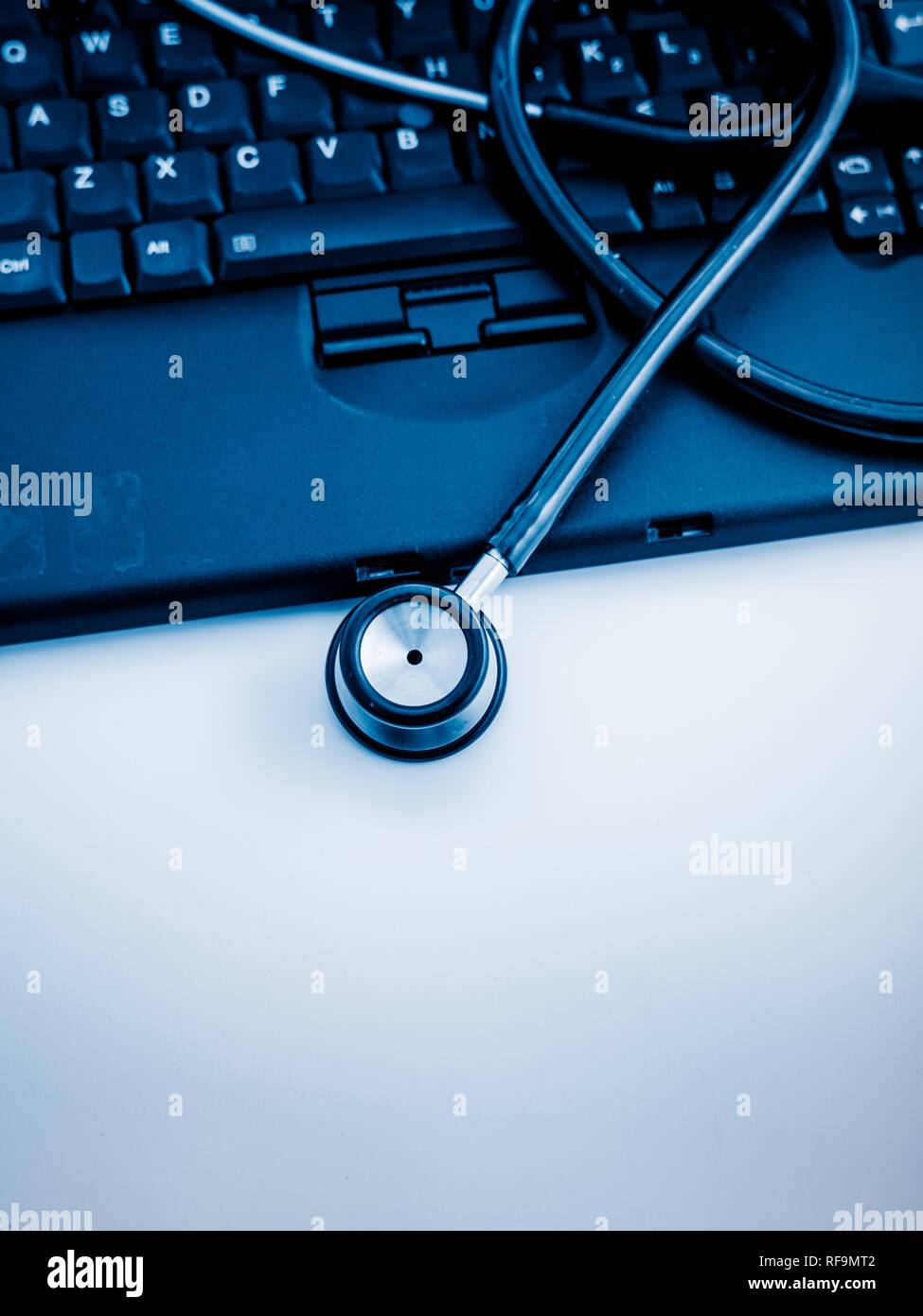 Electronic medical, stethoscope on PC/Laptop/Keyboard， blue toned ...