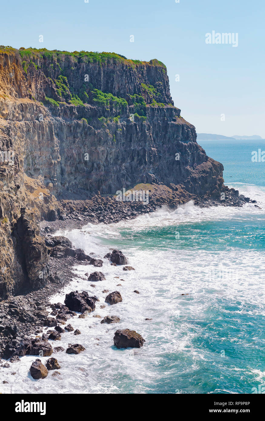 Sunny view of a bright colorful ocean and cliff edge Stock Photo