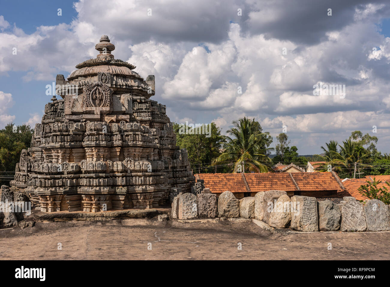 Belavadi, Karnataka, India - November 2, 2013: Veera Narayana Temple. One of three brown-stone Vimana towers of the complex under cloudscape. Shot fro Stock Photo