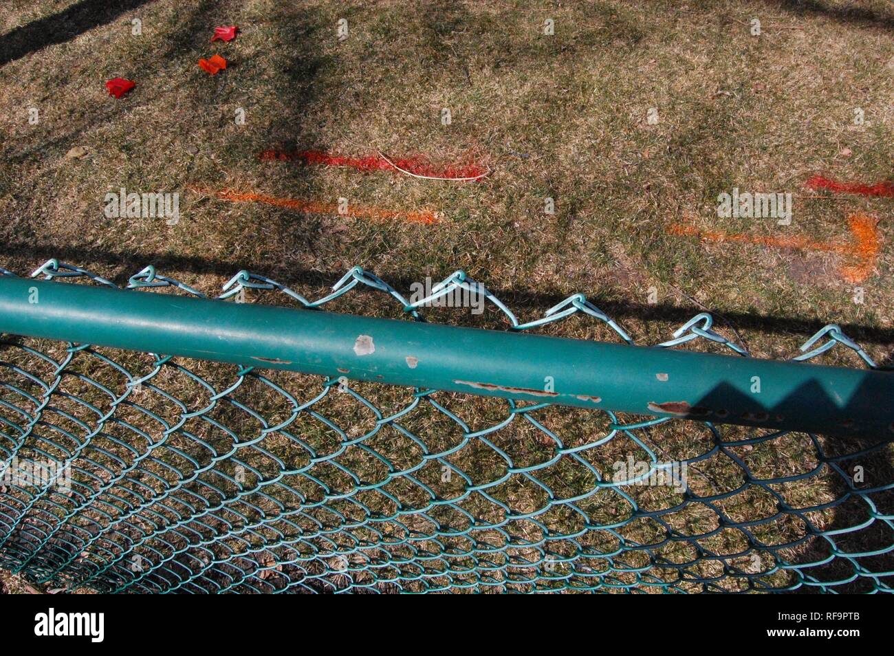 Pre Construction View of Fence with Utility Company Paint Markings on Grass Stock Photo