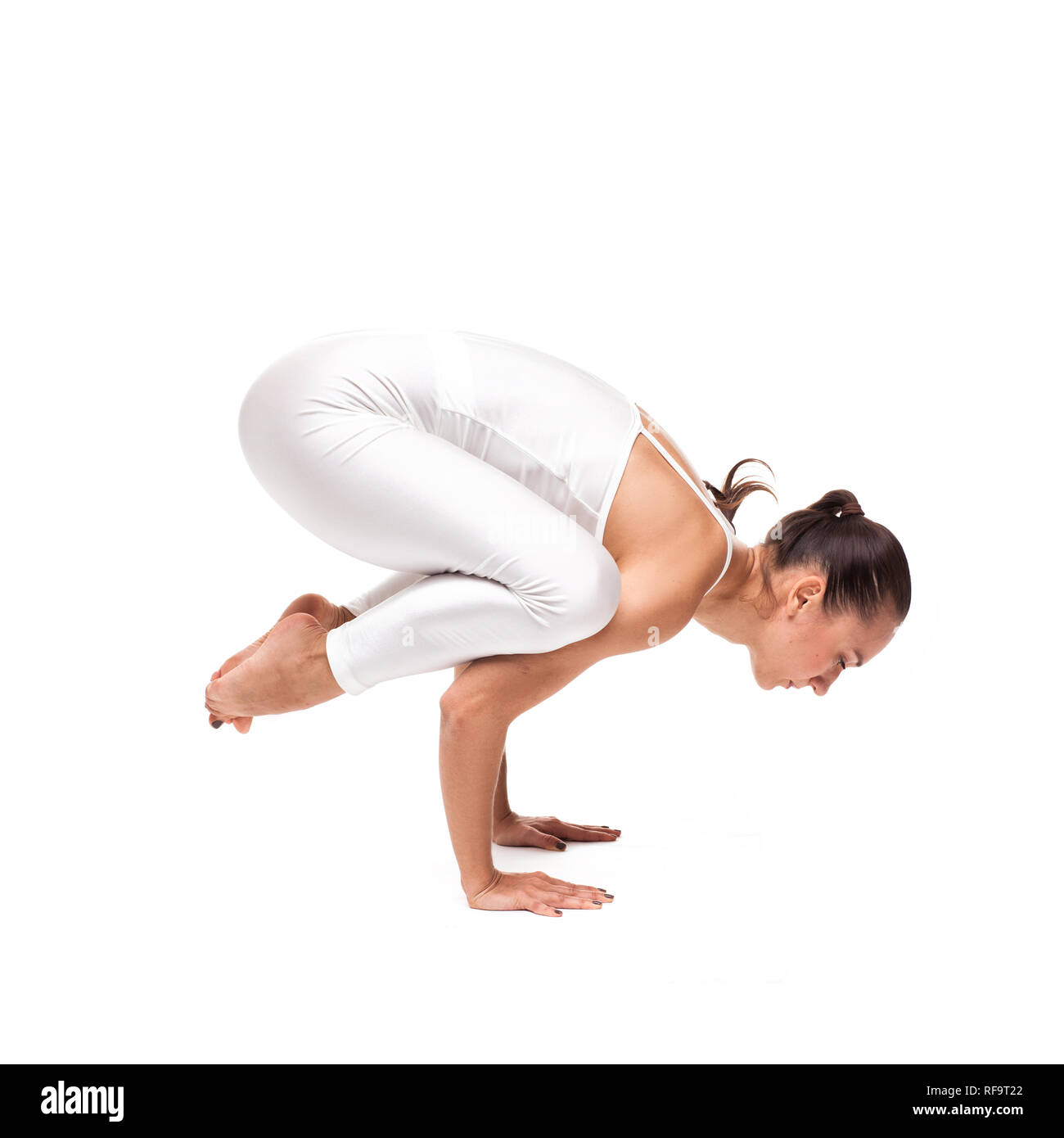 young beautiful woman yoga posing on isolated white studio background ...