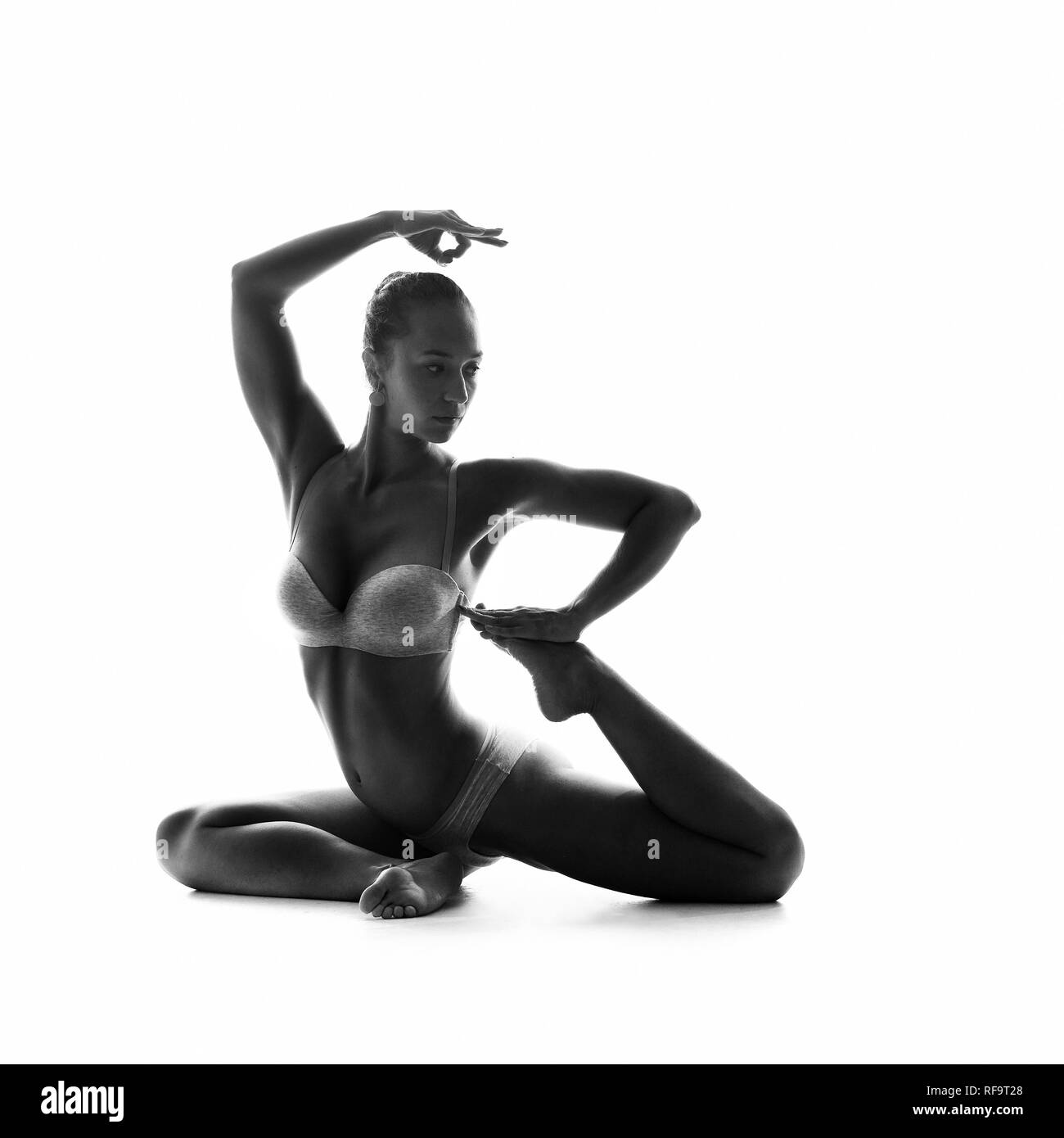 studio shoot of healthy latino woman doing yoga isolated over white Stock Photo