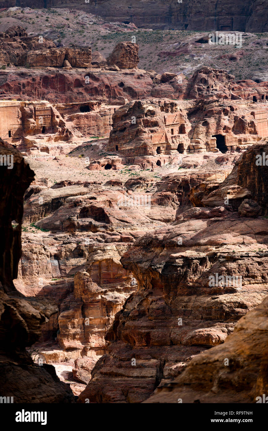 Amazing view of a beautiful canyon in Petra with the historical and archaeological city in distance. Stock Photo