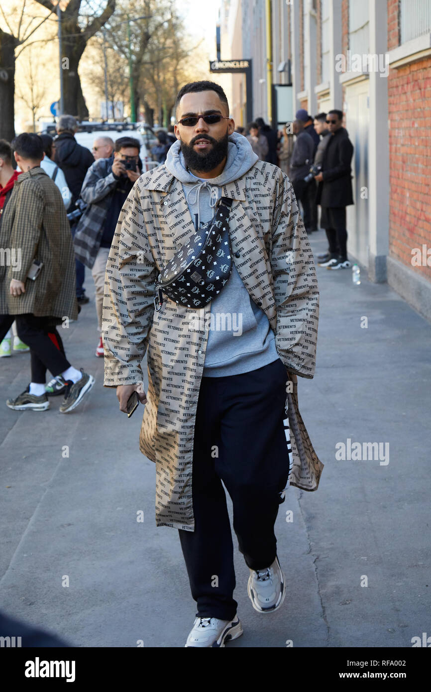 MILAN, ITALY - JANUARY 14, 2019: Man with Vetements beige trench coat and  black leather MCM pouch before Fendi fashion show, Milan Fashion Week  street Stock Photo - Alamy