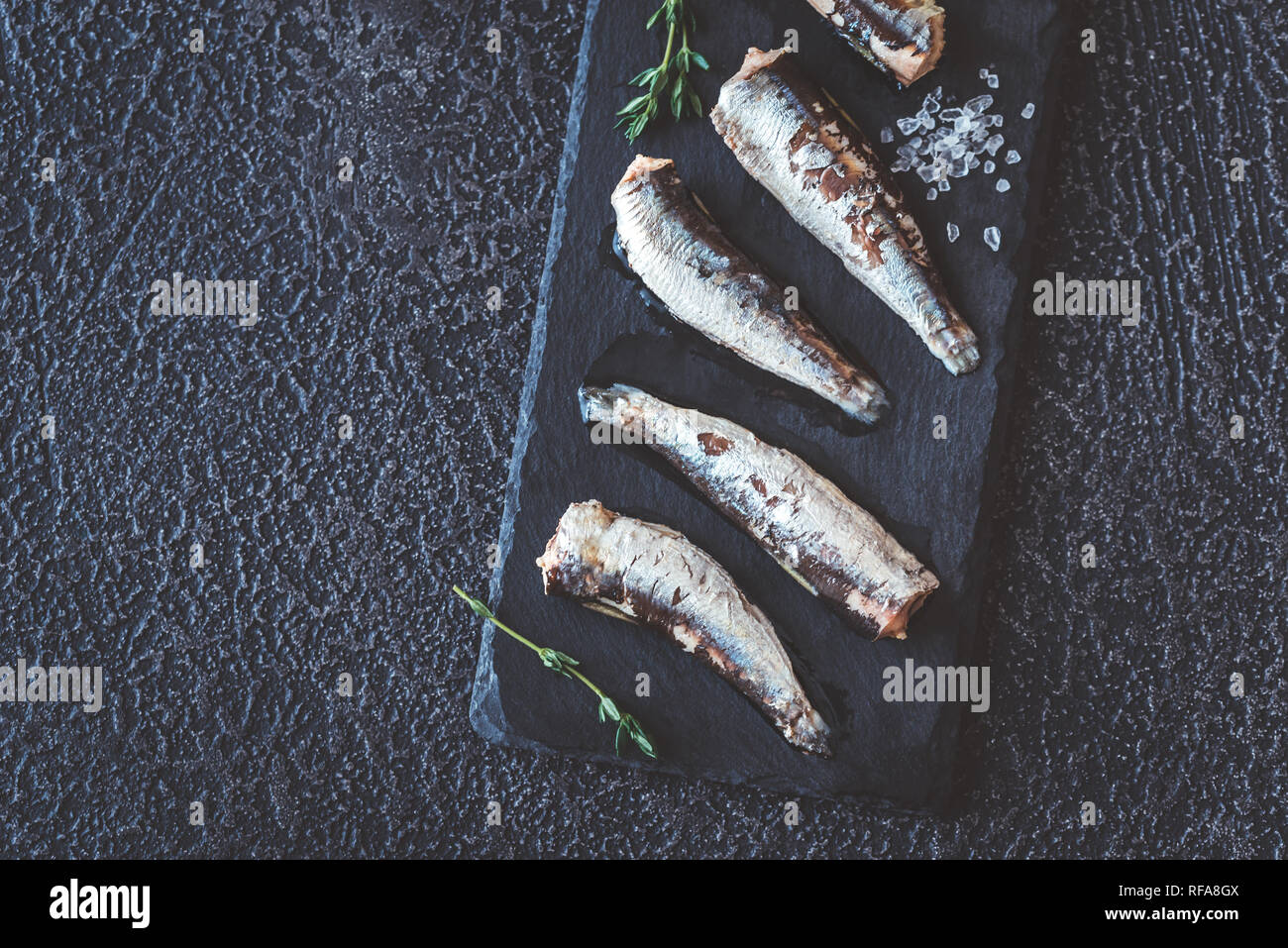 Sardines on the black stone board top view Stock Photo Alamy