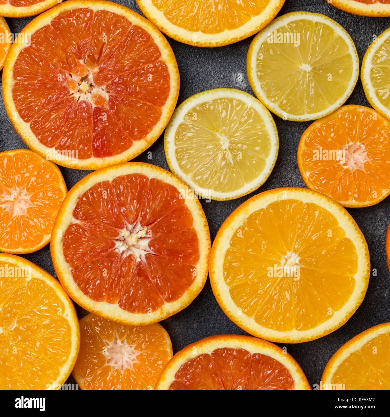 Colorful citrus background with orange, grapefruit, lemon, mandarin at dark background. Space for your text Stock Photo