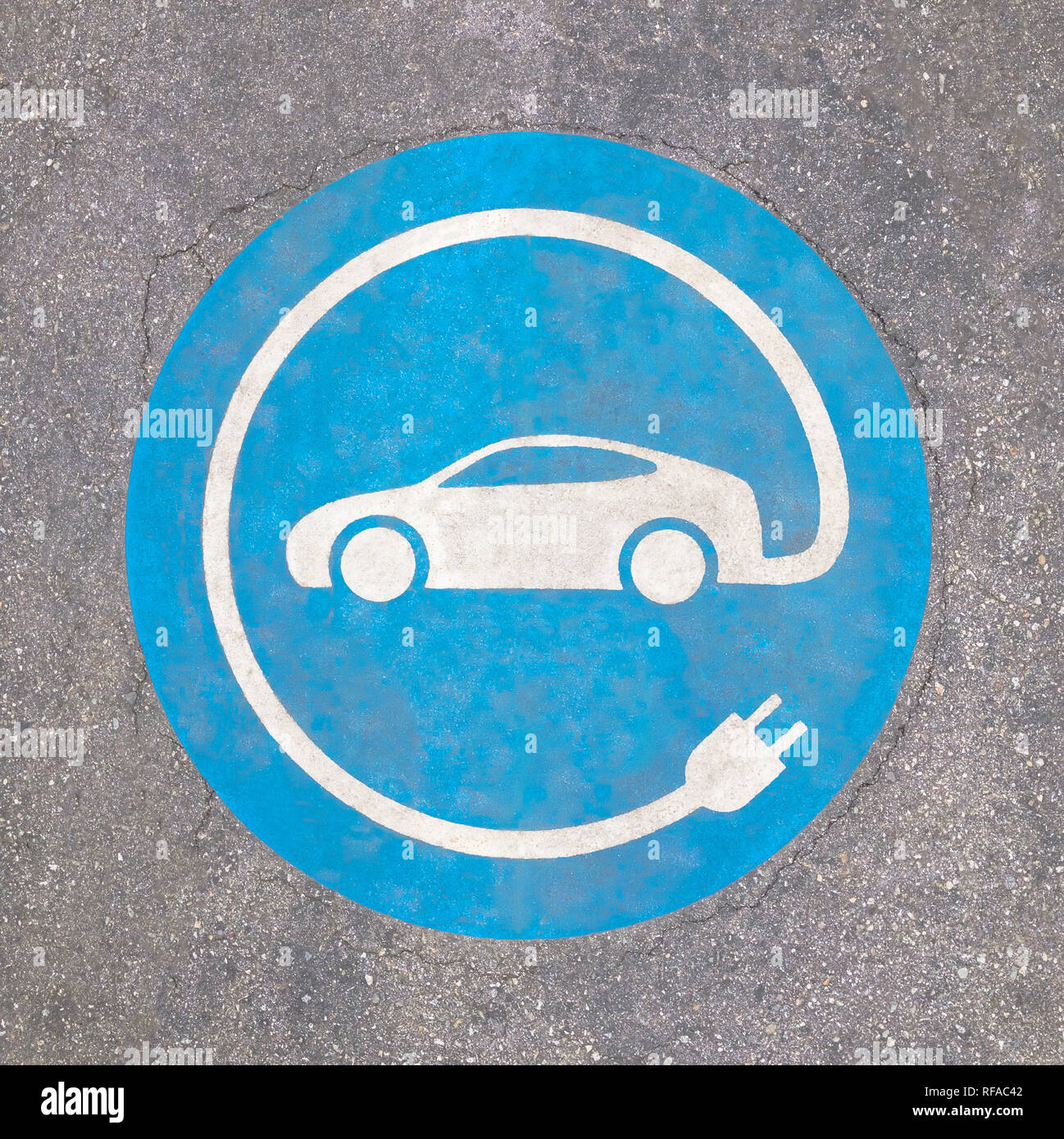 EV - charging station sign on asphalt. 'E' sign on asphalt texture. Stock Photo