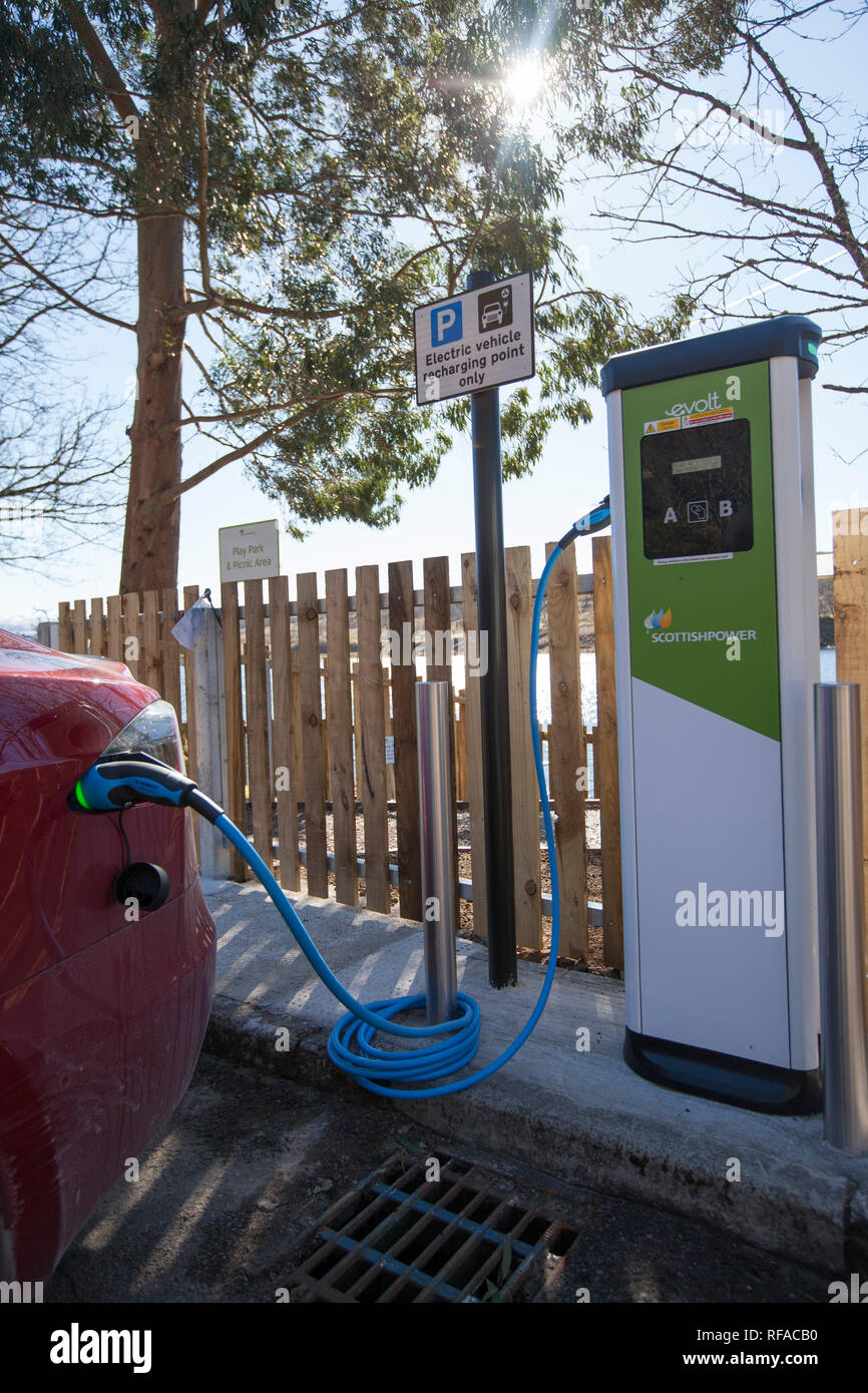 A Tesla car charging. Stock Photo