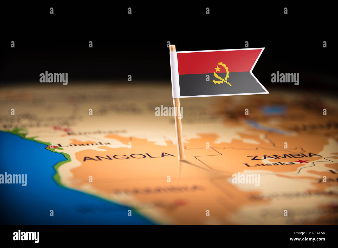 Angola marked with a flag on the map Stock Photo