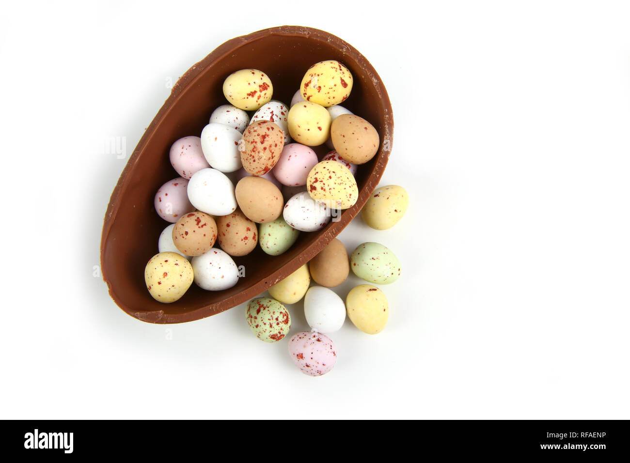 Chocolate mini Easter eggs in half a large chocolate egg basket against a white background Stock Photo