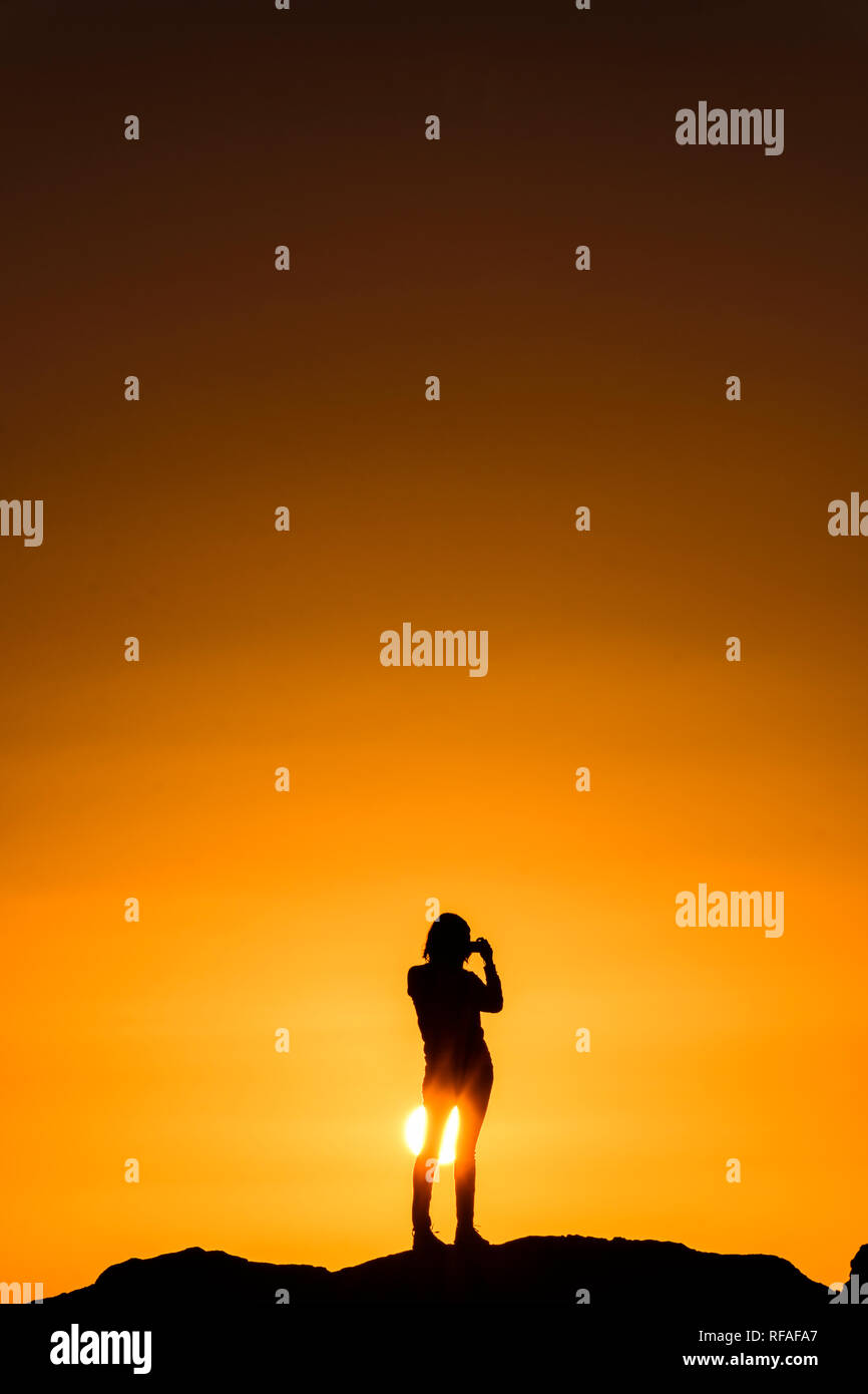 Girl standing in ocean at sunset hi-res stock photography and images ...
