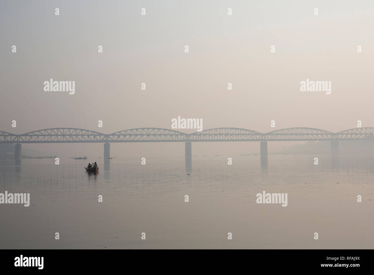 Rajghat bridge on river Ganges at sunrise. Also known as the Malviya bridge it is a double decker bridge with rail tracks on the lower tier and vehicl Stock Photo