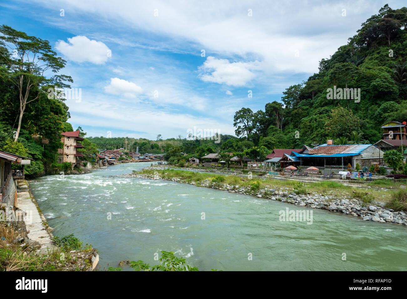 Bukit Lawang village and river view. Bukit Lawang is a popular tourist destination for its jungle trekking tour and orangutans. Stock Photo