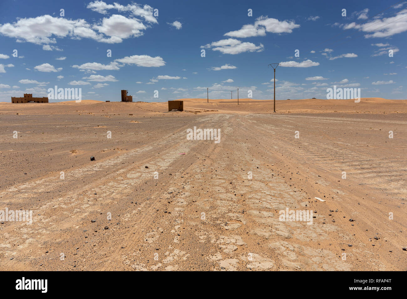 A dirt track leads through Northern sahara desert landscape A dirt track leads through Northern sahara desert landscape