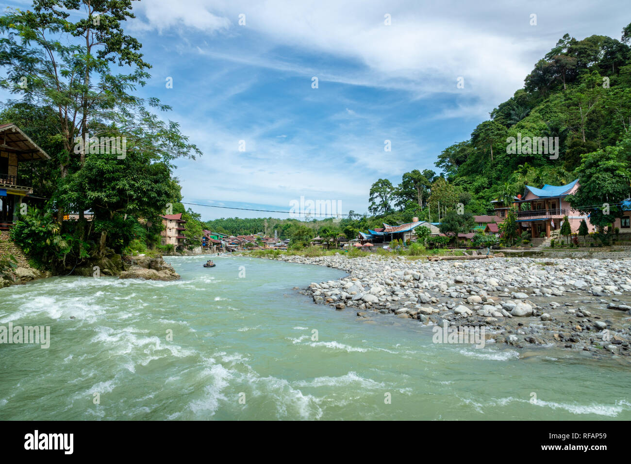 Bukit Lawang village and river view. Bukit Lawang is a popular tourist destination for its jungle trekking tour and orangutans. Stock Photo