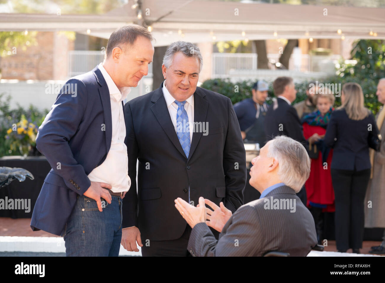 Joe Hockey, center, Australian ambassador to the United States and Austin, Texas, businessman James Messer, left, visit with Texas Gov. Greg Abbott during the Great Mates Australia-Texas Barbecue at the Governor's Mansion in Austin. Abbott and Hockey worked to strengthen ties between the allies discussing agriculture and high tech before eating Australian Vegemite burnt ends and HeartBrand Akaushi beef. Stock Photo