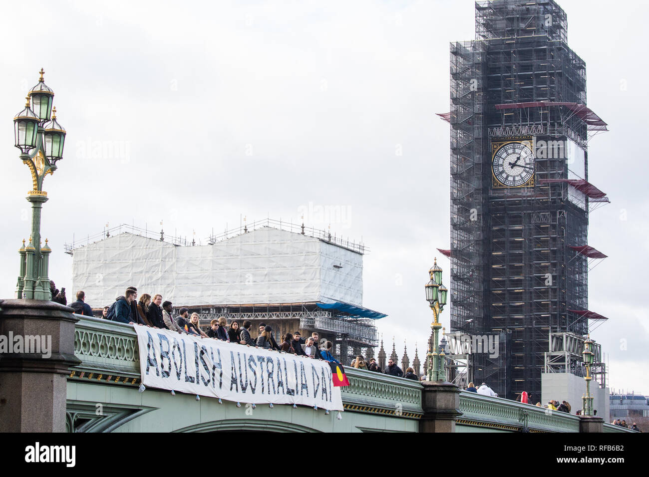 London, UK. 25th January, 2019. Activists drop a banner from Westminster Bridge, in view of the Houses of Parliament, to call for the abolition of Australia Day in advance of rallies in every Australian city tomorrow. The event was organised in solidarity with Aboriginal and Torres Strait Islander people who consider Australia Day, a day celebrating the colonisation of Australia, to be a day of mourning rather than a day of celebration. Credit: Mark Kerrison/Alamy Live News Stock Photo