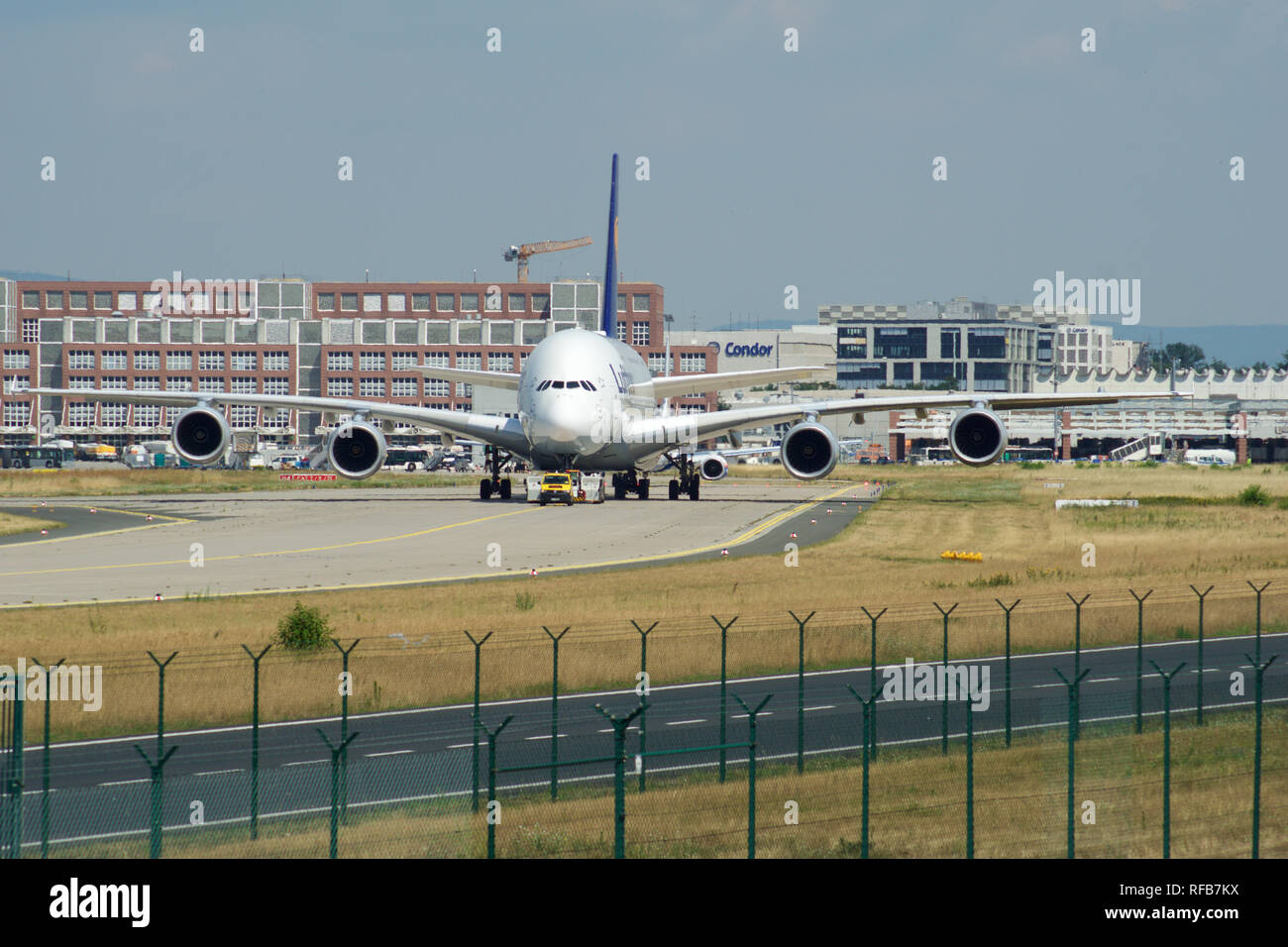 FRANKFURT, GERMANY - JUN 09th, 2017: Airbus A380 of Lufthansa with registration D-AIMH moves on taxiway by tow truck before departure from FRA airport Stock Photo