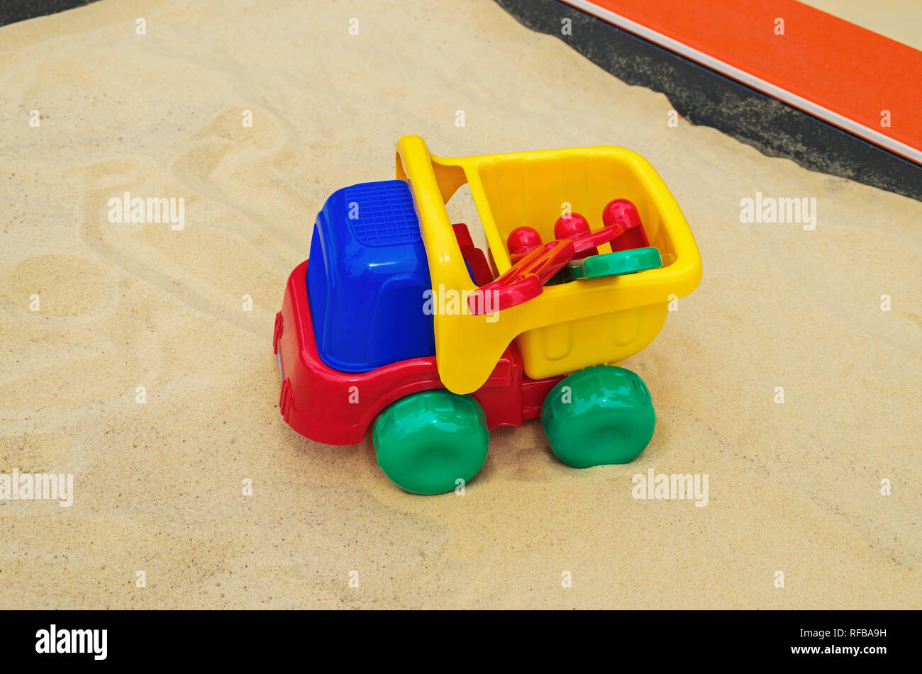 Toy truck in sandbox on the childrens playground in city entertainment