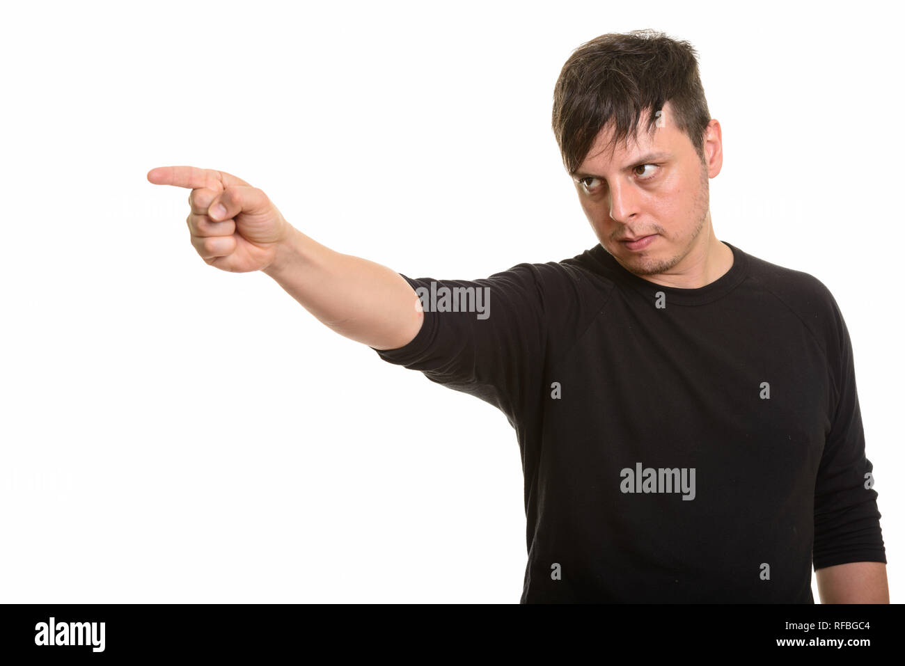 Studio shot of angry Caucasian man pointing finger Stock Photo