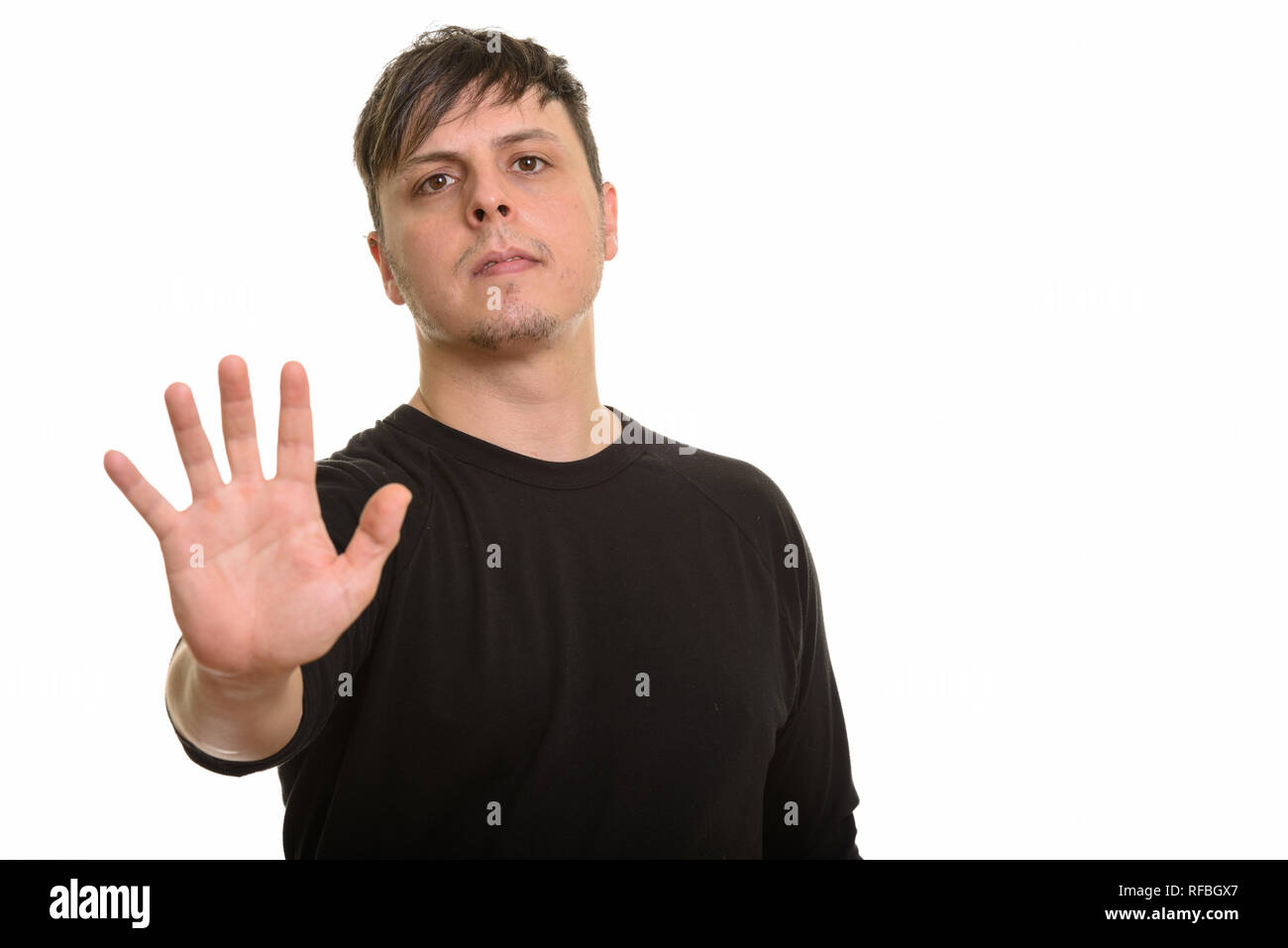 Studio shot of Caucasian man with stop hand gesture Stock Photo