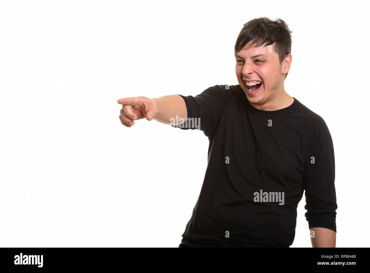 Studio shot of Caucasian man laughing and pointing finger Stock Photo