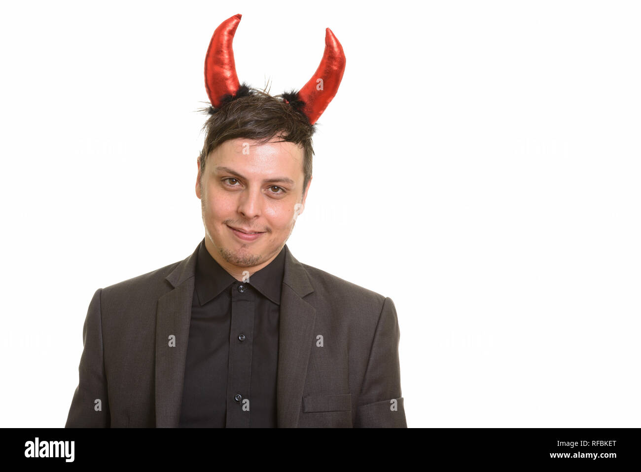 Studio shot of happy Caucasian businessman wearing devil horns Stock Photo