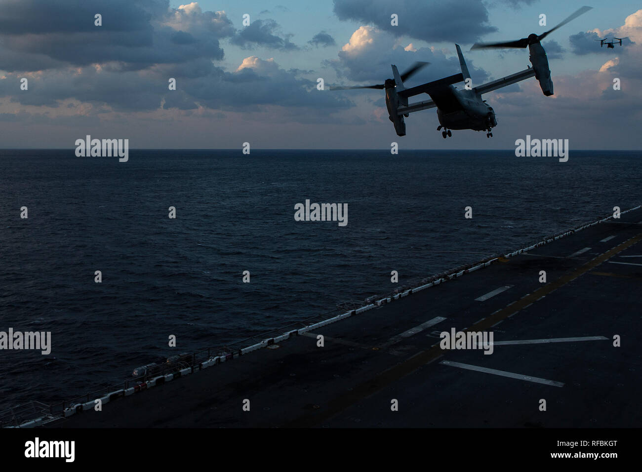 An MV-22B Osprey tiltrotor aircraft belonging to Marine Medium Tiltrotor Squadron 262 (Reinforced) takes to the sky during flight operations aboard the amphibious assault ship USS Wasp (LHD 1), underway in the Philippine Sea, Jan. 23, 2019. Naval aviators with VMM-262 (Rein.), the tiltrotor component of the 31st Marine Expeditionary Unit's Aviation Combat Element, perform a wide variety of aviation missions for the 31st MEU, including troop transport, heavy and medium lift, fixed-wing attack support and aerial reconnaissance. The 31st MEU, the Marine Corps’ only continuously forward-deployed M Stock Photo