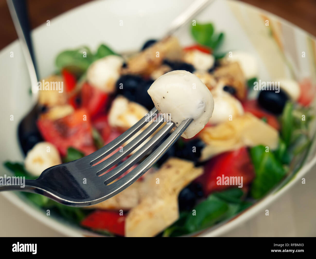 Closeup view of a bowl full of Mozzarella salad. Stock Photo