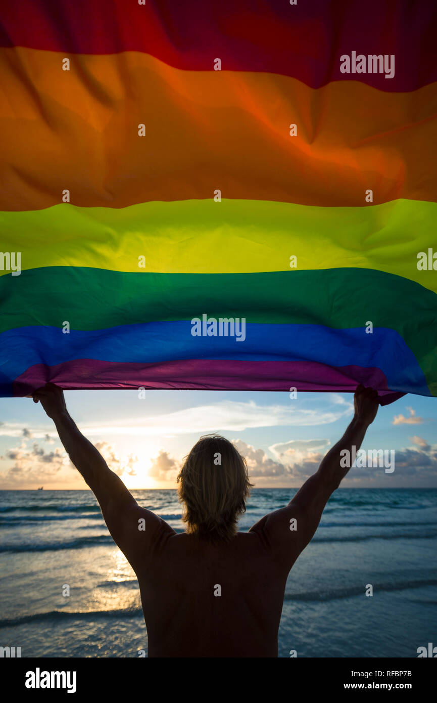 Colorful Sunset Silhouette Of A Man With Blond Hair Holding A