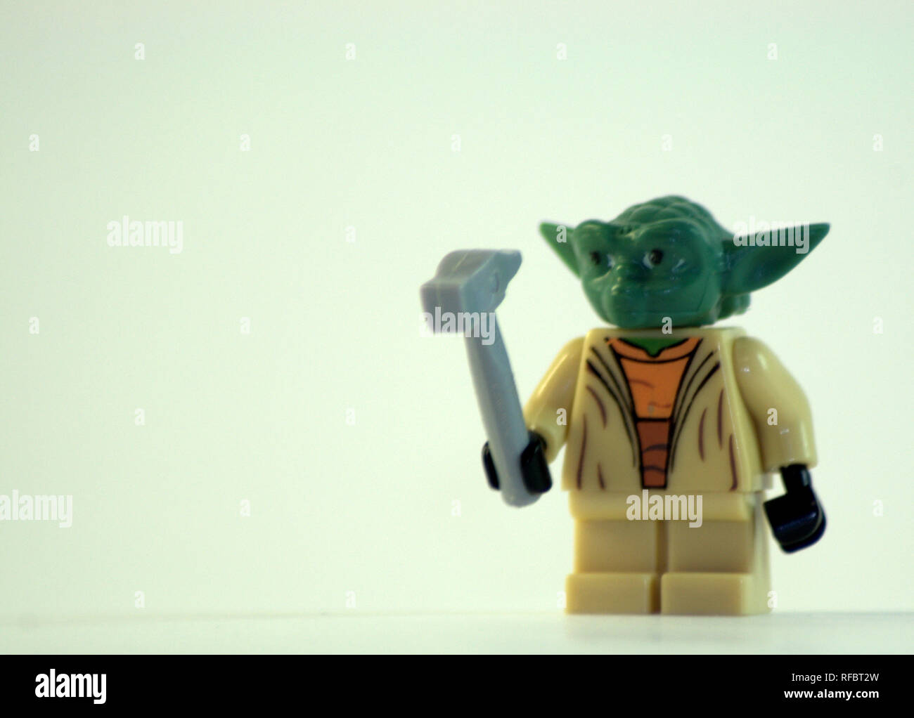 Grand Master Yoda with a hammer in his hand made of plastic. May the force  be with you ... The picture was taken in close-up on a white background  Stock Photo -