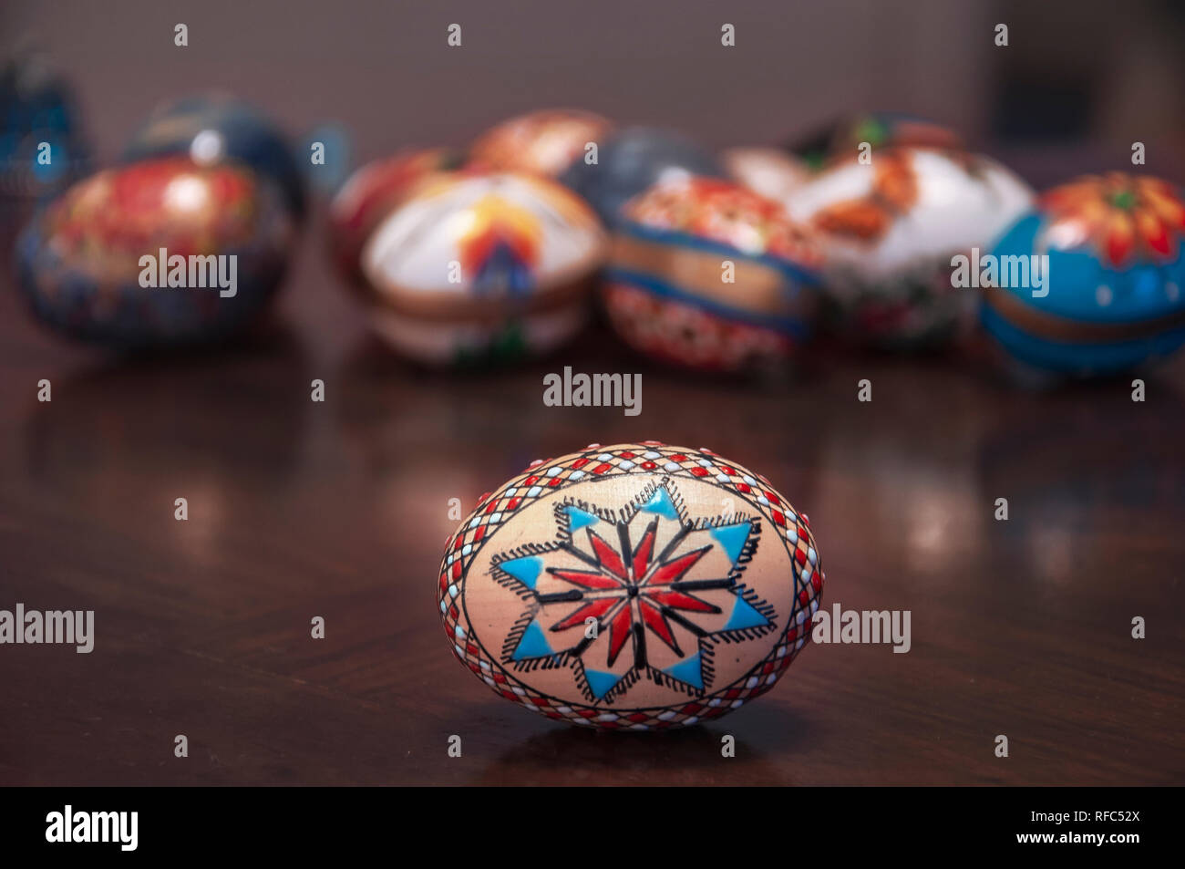 Painted colorful easter eggs on wooden table Selective focus Stock Photo