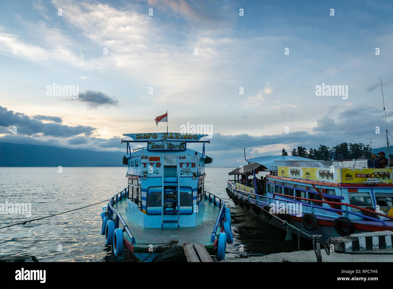 Lake Toba, Indonesia - January 2018: Ferries for passengers on Lake Toba at sunset, North Sumatra Indonesia. Stock Photo