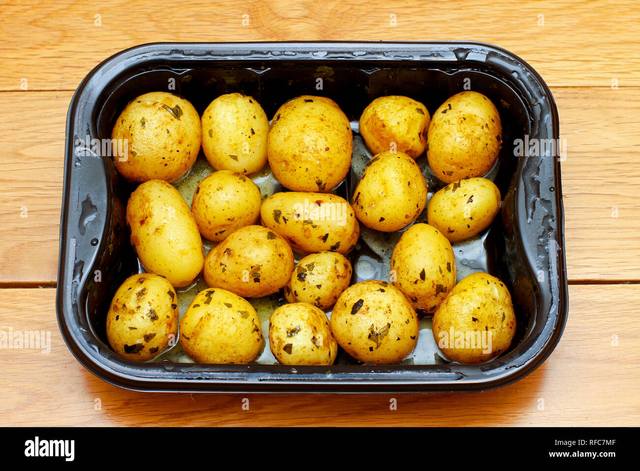 Prepared small potatoes in plastic microwave pot Stock Photo Alamy