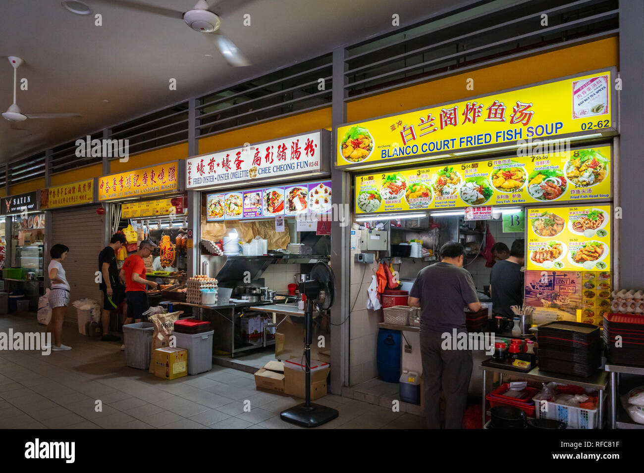 Singapore - January 2019: Street food stalls in hawker center in Singapore central area. Hawker centers are inexpensive open-air food courts Stock Photo