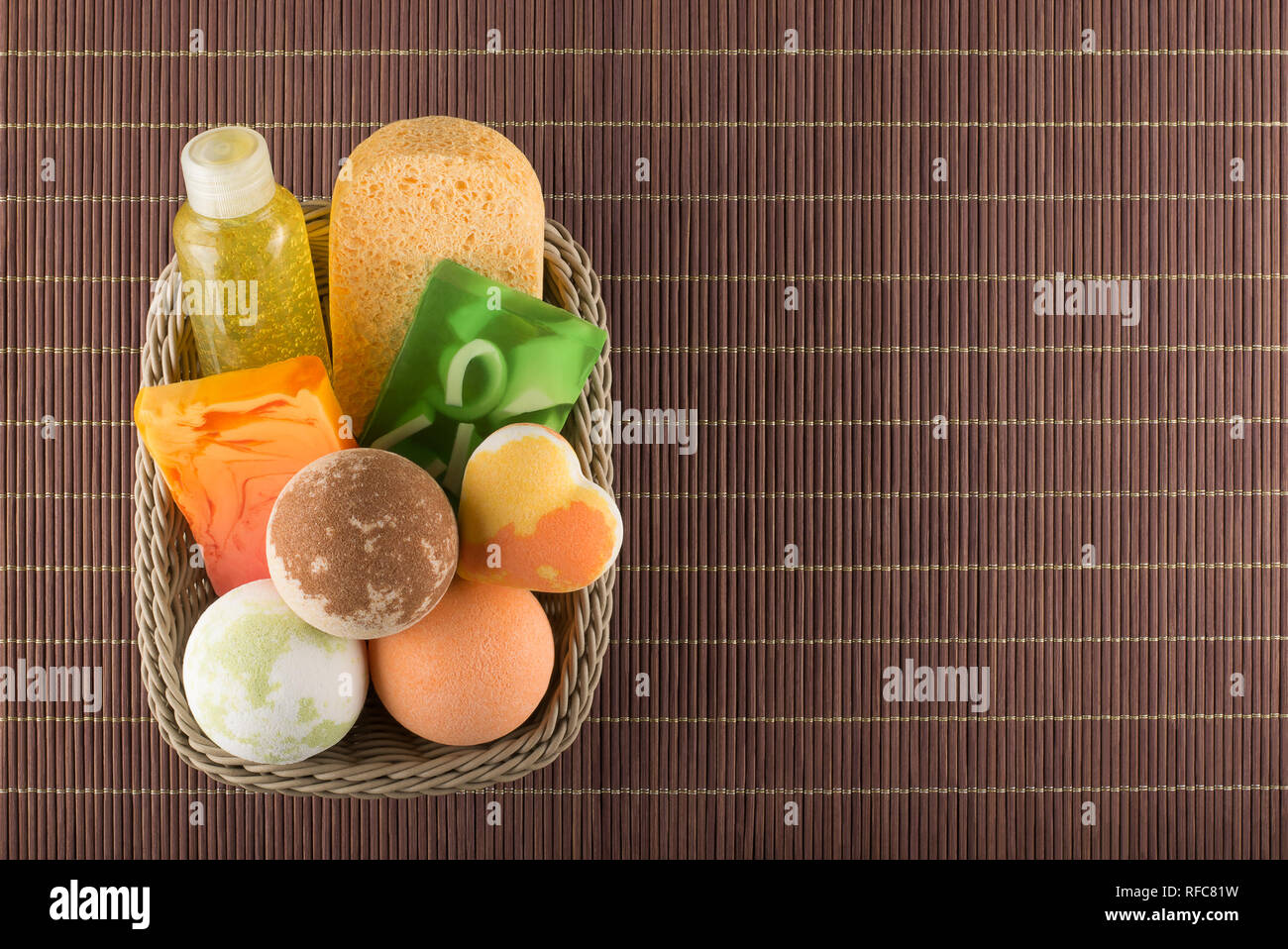 Сosmetic bath products in the basket on a bamboo placemat Stock Photo
