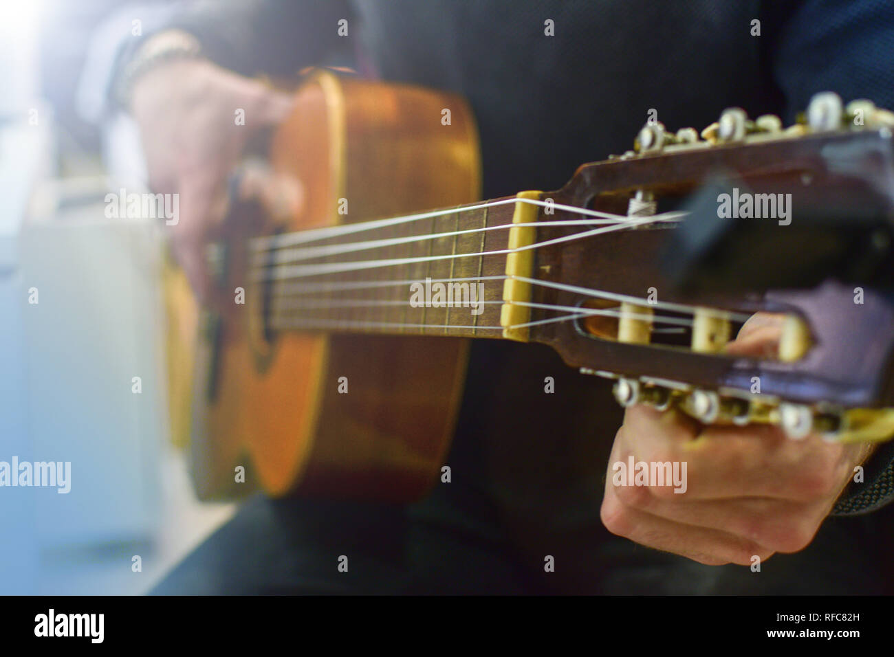 Man tuning acoustic spanish guitar. Play guitar lesson Stock Photo Alamy