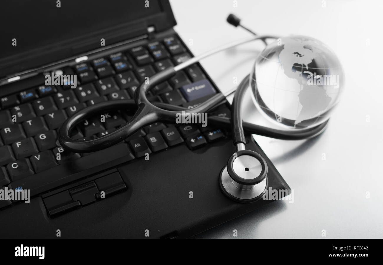 Glass globe and stethoscope on a computer keyboard Stock Photo - Alamy